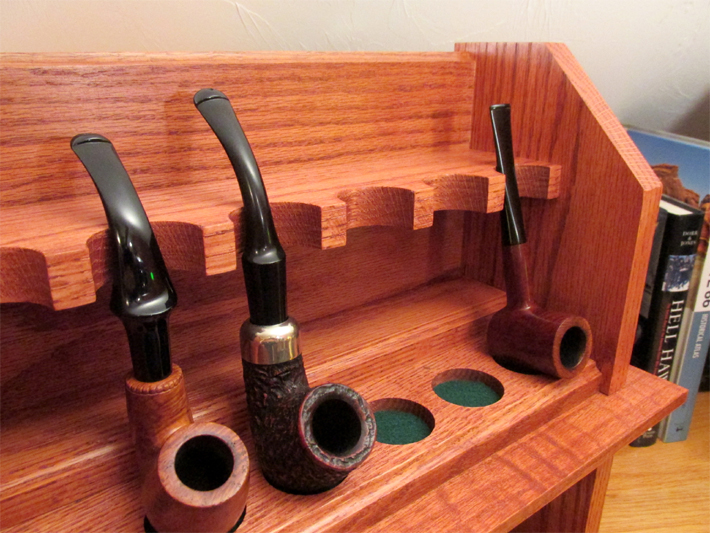 Right top close up of a craftsman style smoking pipe rack
