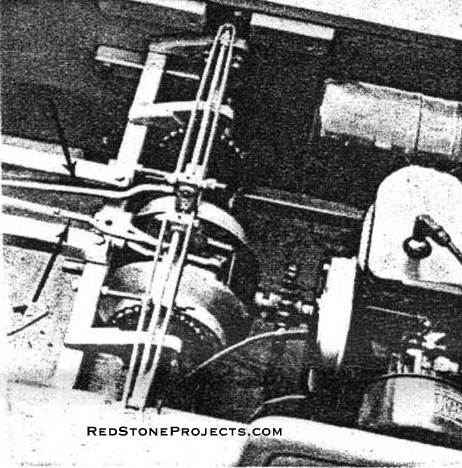 TAT (left) coupled to engine (right) is controlled by rods from hand lever (arrows).