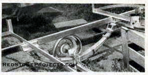 Travel trailer spring, axle and shackle arrangement.