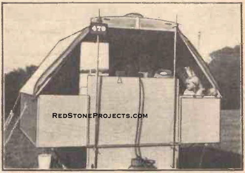 Cutaway view of the truck camper interior showing the kitchen and fold-down dining table.