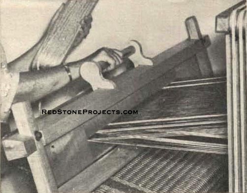 Figure 6. Pulling beater toward breast beam, shed still open after throwing shuttle wedges weft between upper, lower threads.