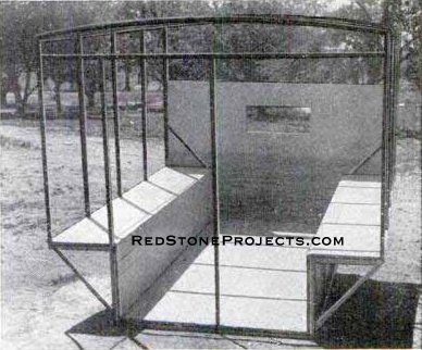 The angle-iron frame of the Pick-A-Back trailer body with the floor and front pane installed. Note the front window opening.