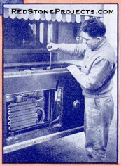 A tourist pumping up the air presure tank that supplies water to the sink. The coils serve the refridgerator unit.