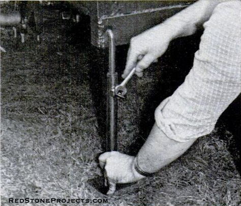 Telescoping feet at each corner level trailer at campground. Wrench is used to tighten set screw over a range of about 9 in. a wire hook on the frame holds up leveling foot on the road.